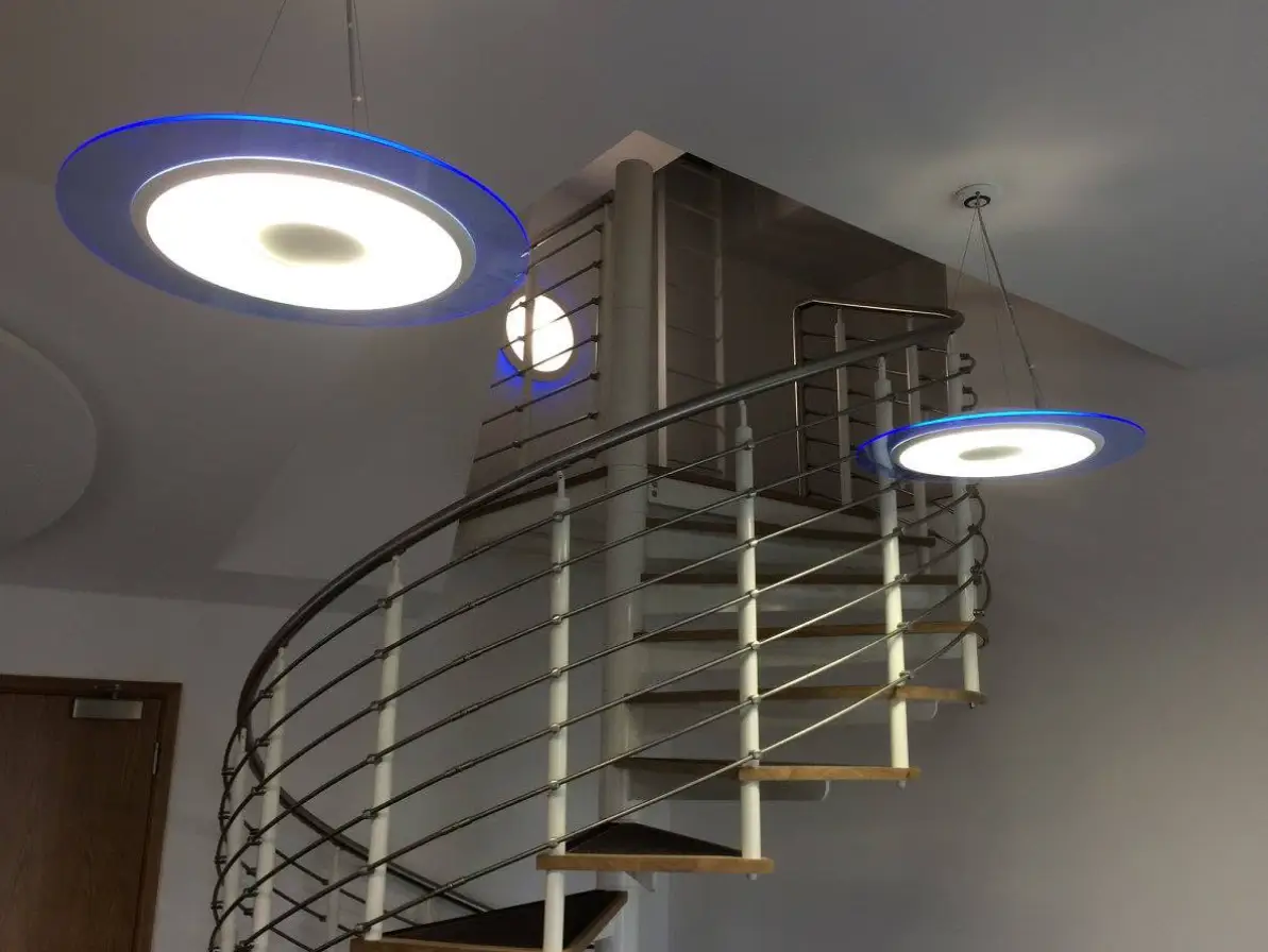 Spiral metal staircase with industrial decorative pendant light